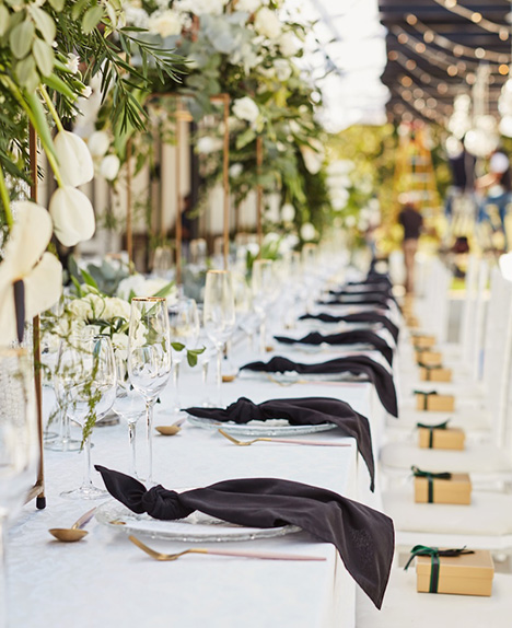 Elegant tented event with rental tables, linens and chairs